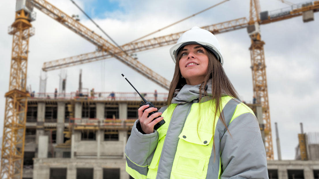 Civil engineering student with hard hat at construction site