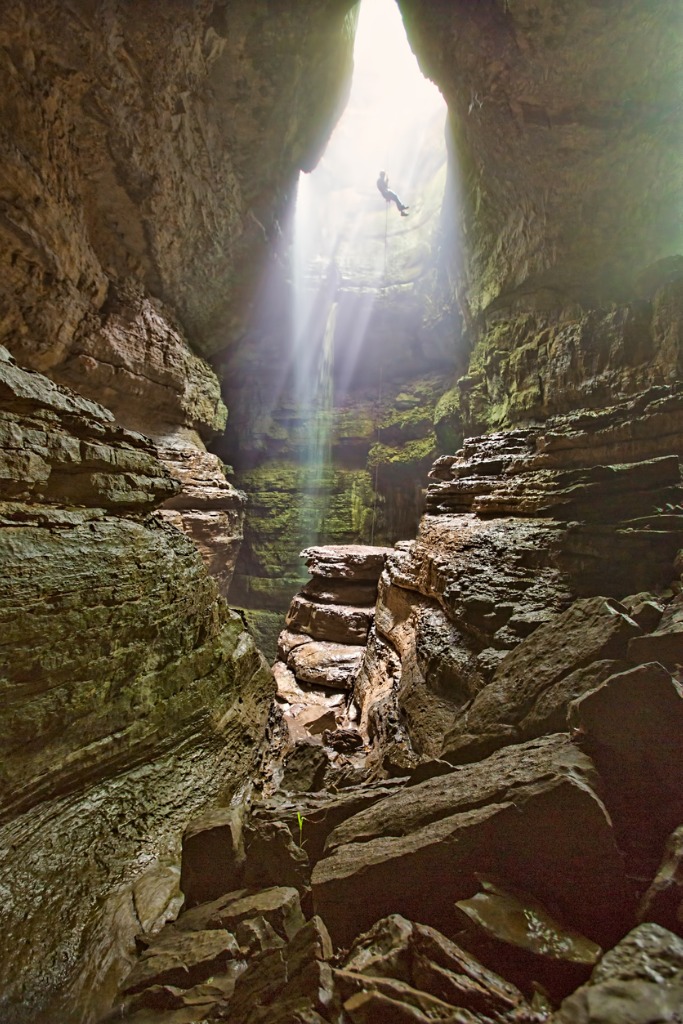 Near Huntsville Alabama, Stephens Gap is a well known spot for cavers. The backlighting created a nice unrecognizable silhouette of the person descending into the cave. The waterfall and sun rays create a wonderful scene.