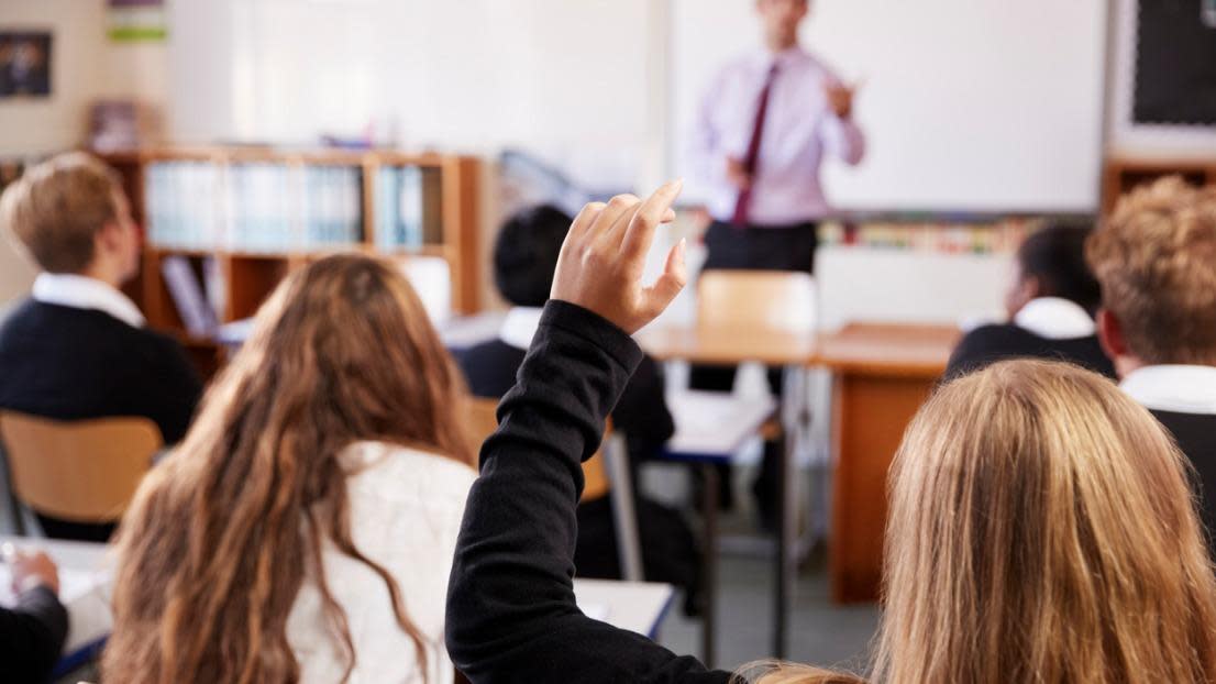 Student raising hand in class