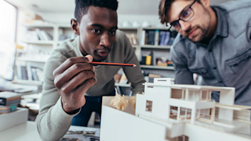 Student architects in office discussing construction project