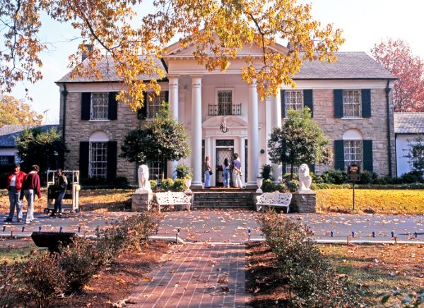Front view of Graceland, the home of Elvis Presley with tourists enjoying the sights, during the Autumn, Memphis, Tennessee, United States of America.
