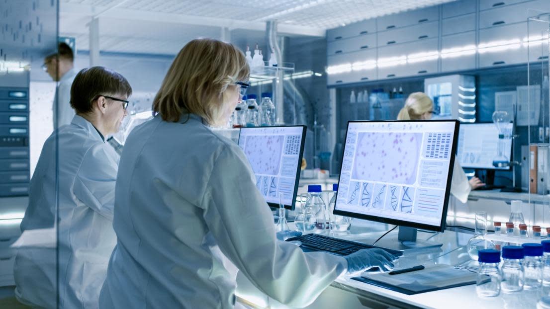 Scientists Working on their Computers In Big Modern Laboratory