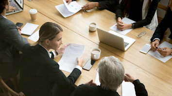 Negotiations with lawyer and businesspeople discussing deal details at group meeting