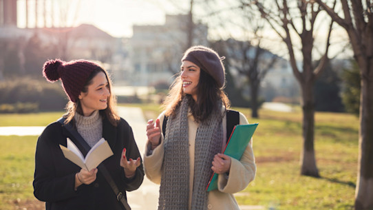 December 2024 open days-happy female students In public park - iStock - Credit: Sladic