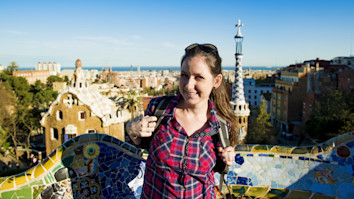  Female student tourist posing in Parc Guell in Barcelona, Spain.