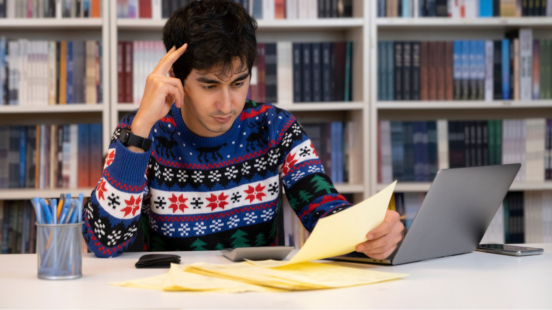 Student wearing a Christmas jumper in the library - Credit: necati bahadir bermek - Stock photo ID:1359623743