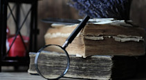 Old books with an magnifying glass
