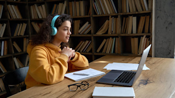 Student checking her application offers on her laptop