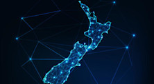 An artistic, electric blue map of New Zealand, with its islands depicted within a prism