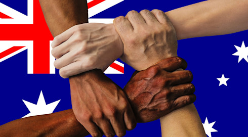 Four hands symbolise strength in unity by clenching each other's accompanying arms to form a square over the flag of Australia