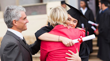 Happy student hugging her mother after graduation