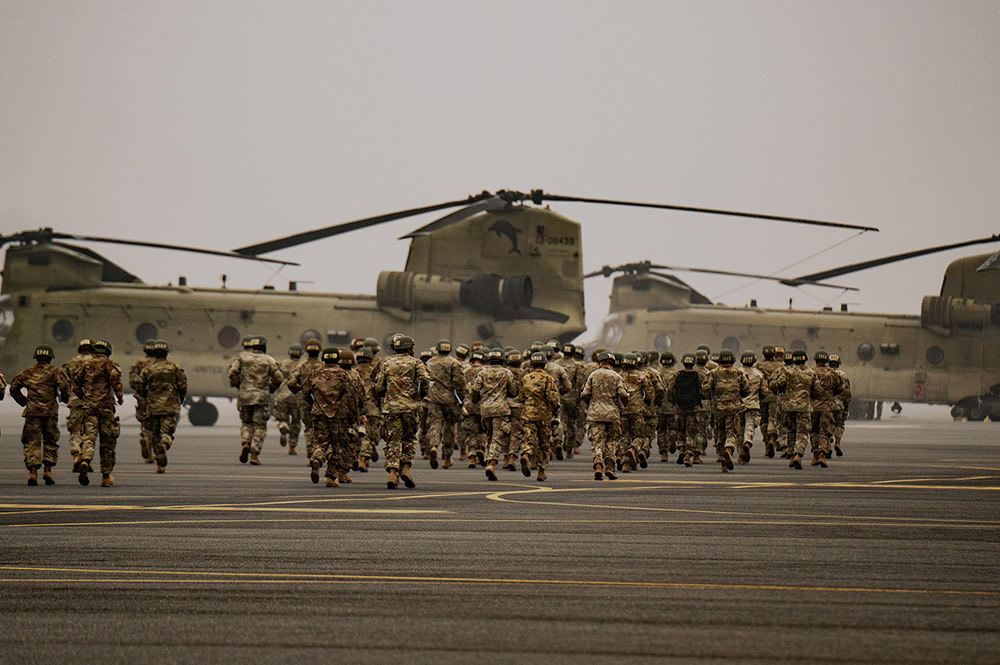 soldiers walking toward plane