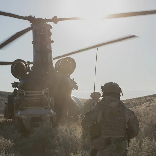 soldier walking towards helicopter