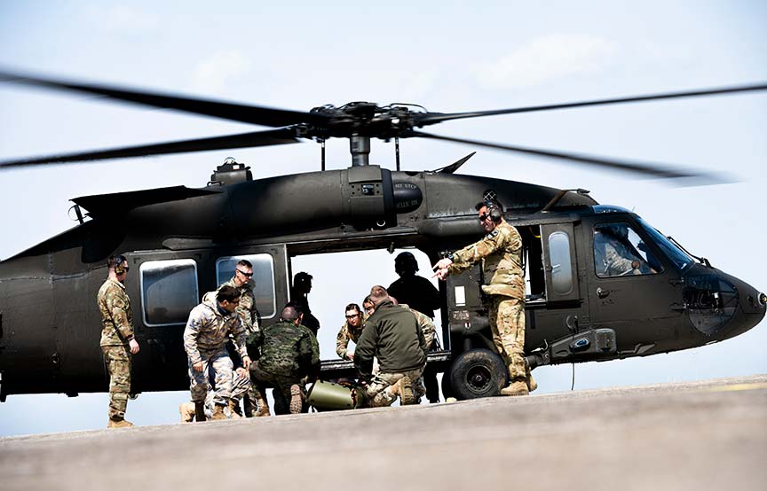 soldiers gathered outside of helicopter 