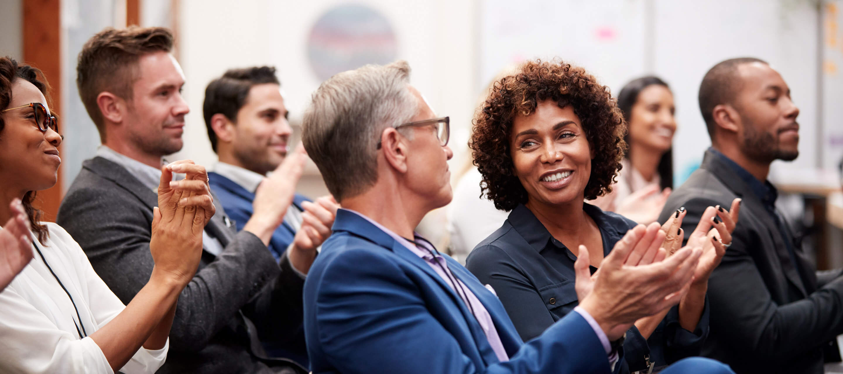 colleagues clapping together while seated