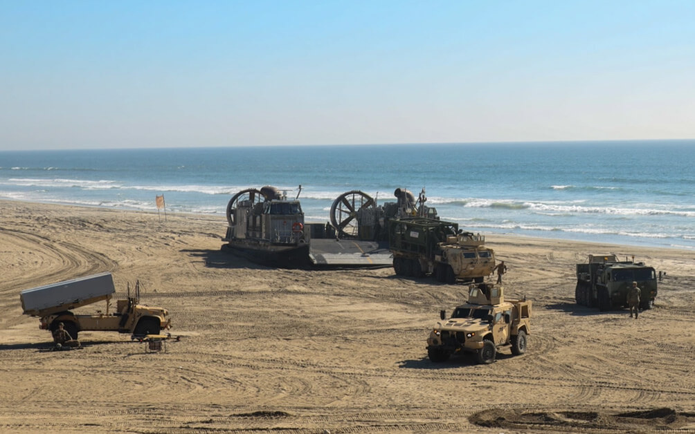 military trucks on a beach
