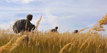 soldiers walking in a field