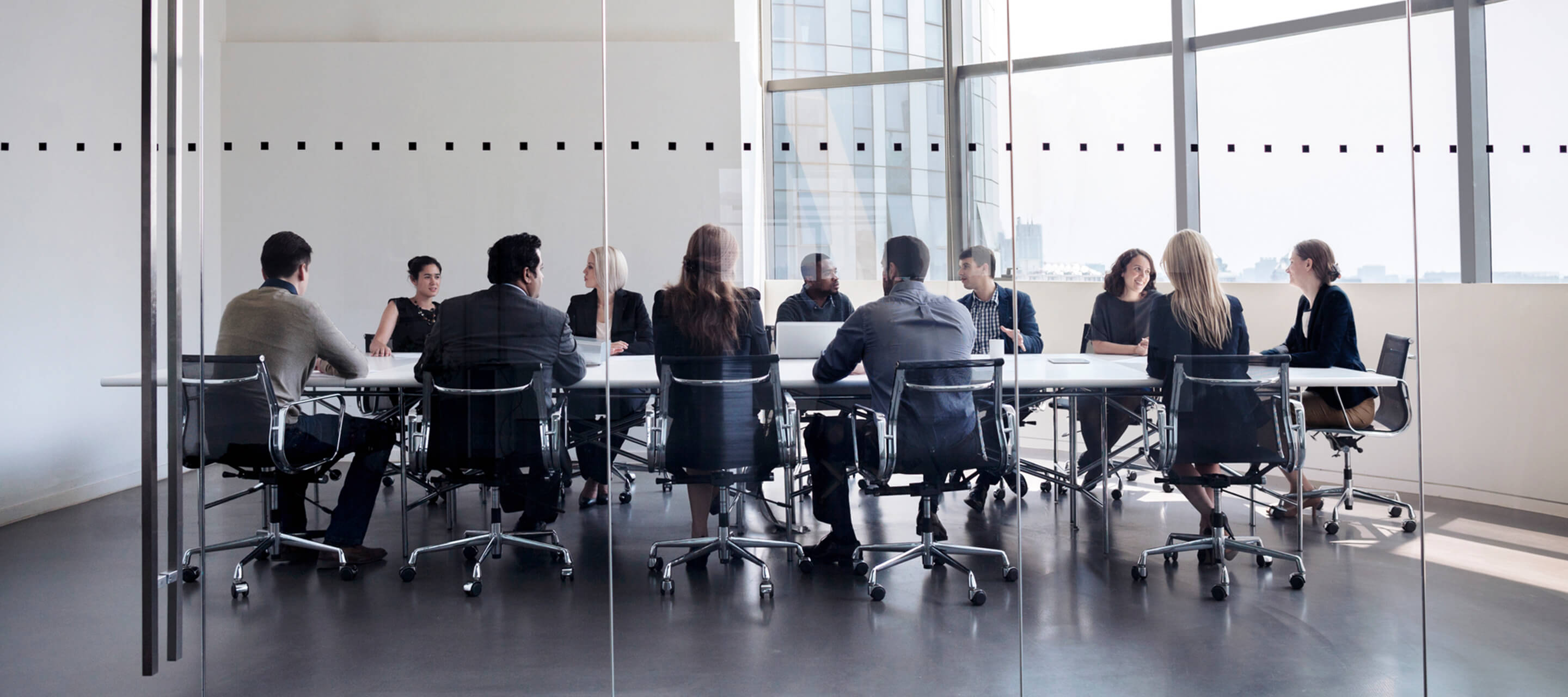 group of people sitting in a conference room