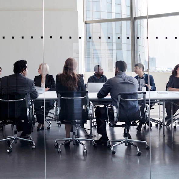 group of people sitting in a conference room