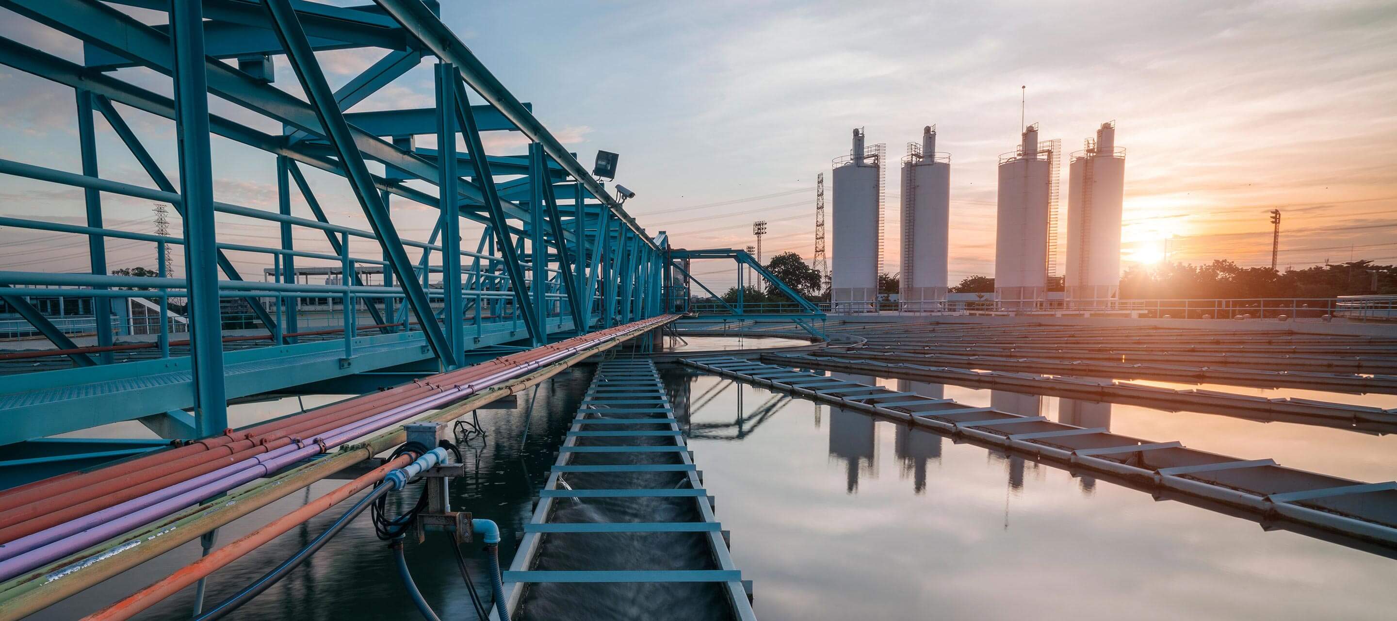 image of bridge and water tanks at sunset