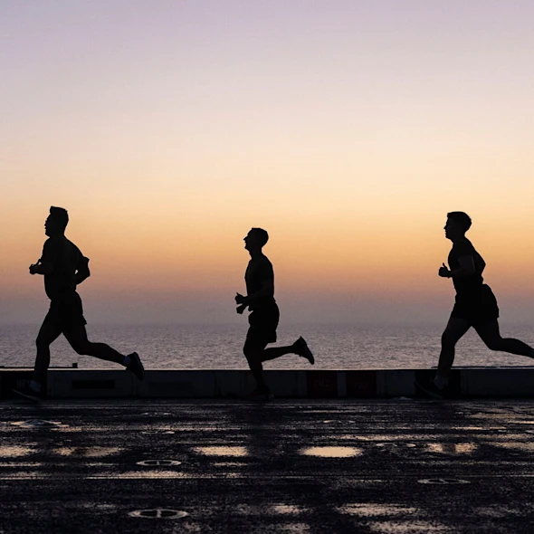 silhouettes of people running