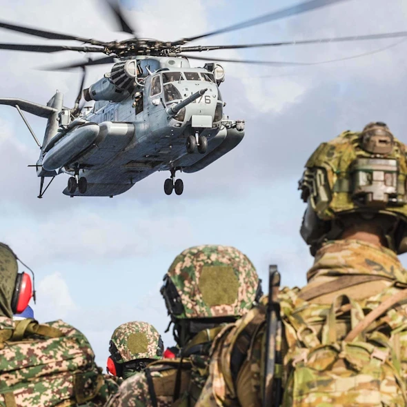 soldiers looking at a helicopter