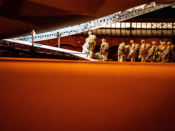 soldier lined up getting on plane 