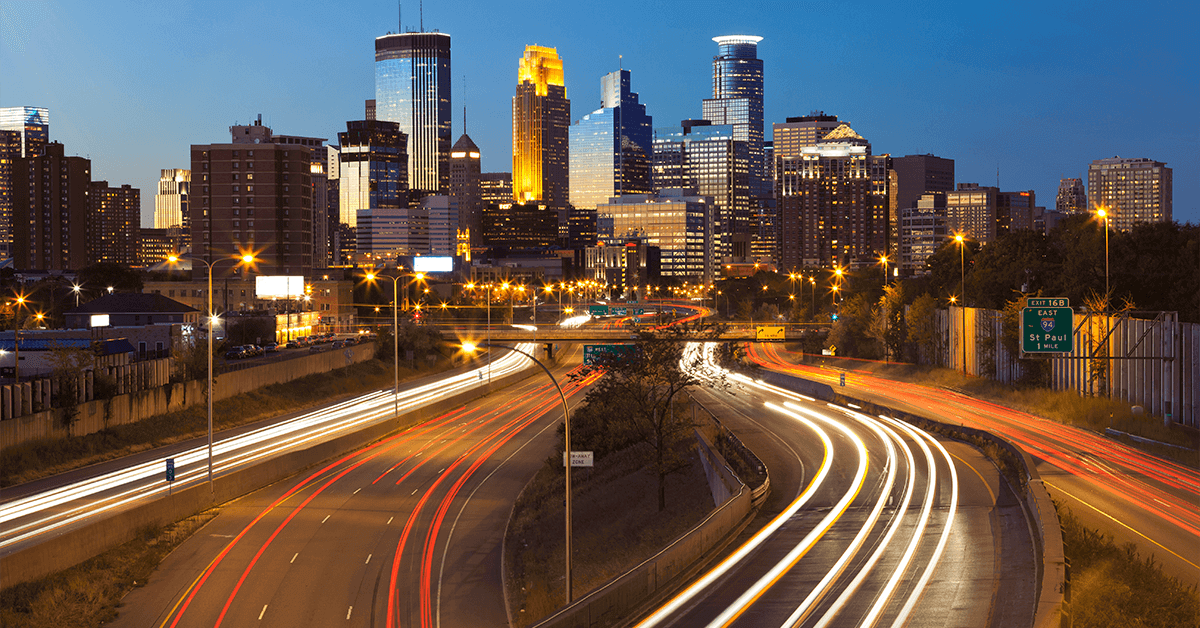 city with lit up roads from cars driving