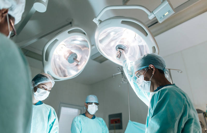 doctors in an operating room under bright lights