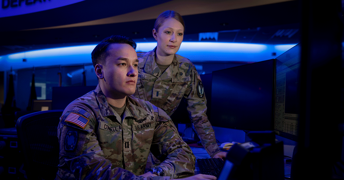 a male and female soldier by the computers 