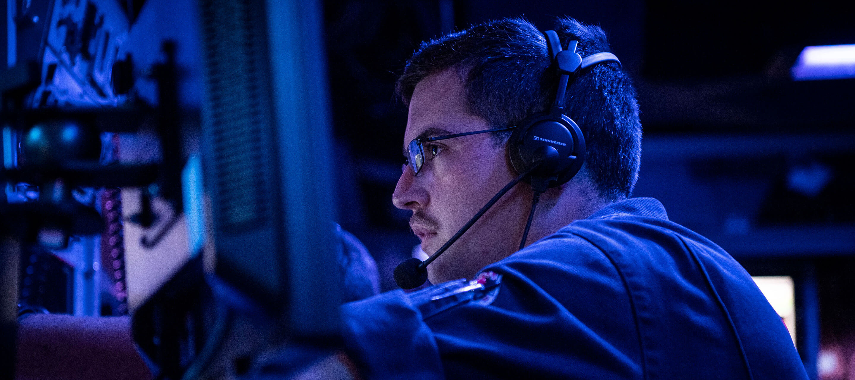 man with headset working on a computer 