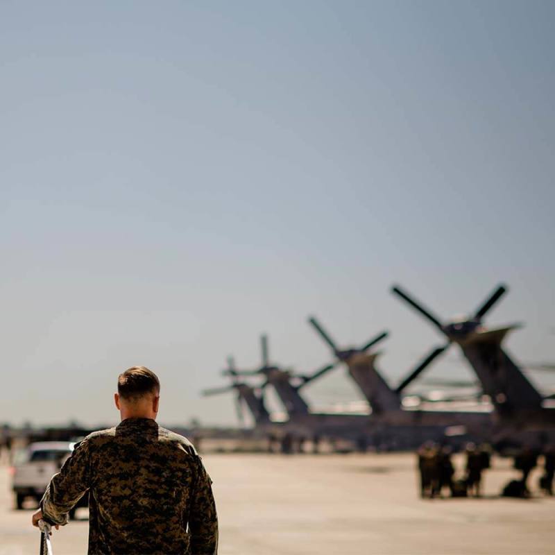 military man walking near the helicopters 