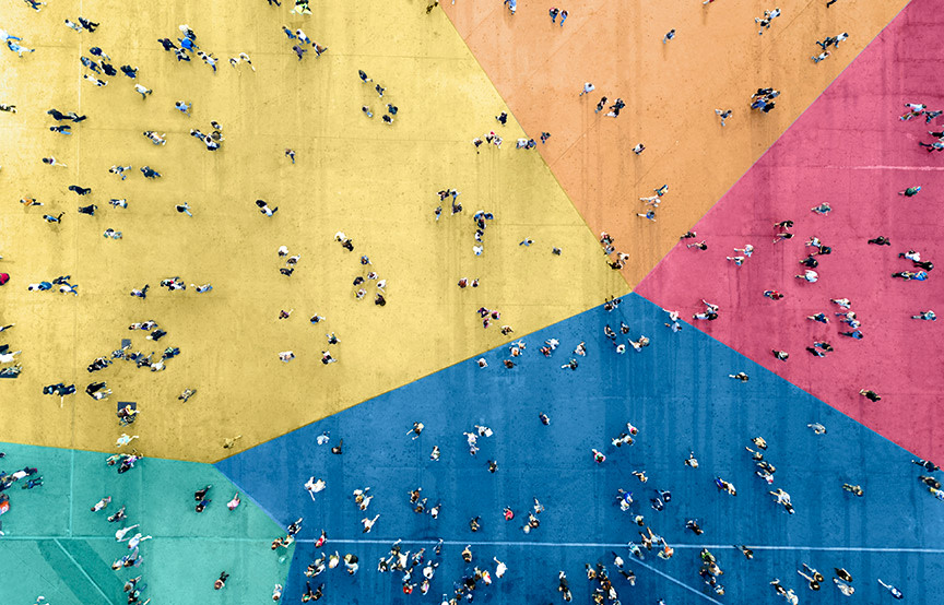 aerial view of people walking across colorful floor