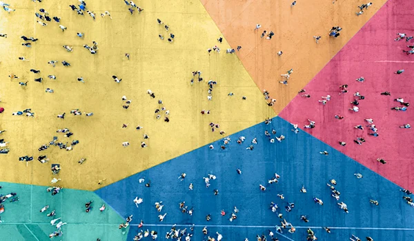 aerial view of people walking across colorful floor