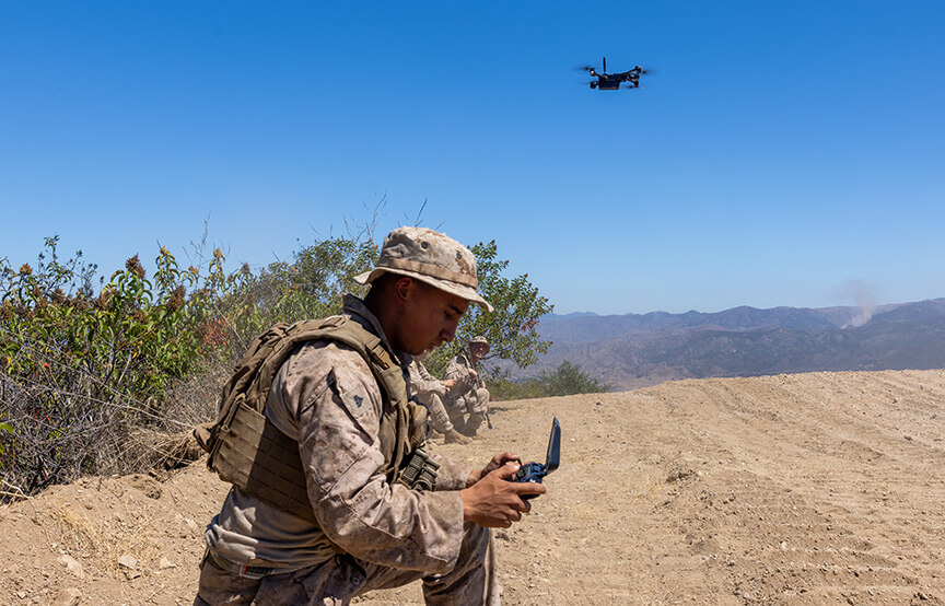 soldier looking at gps with drone above 