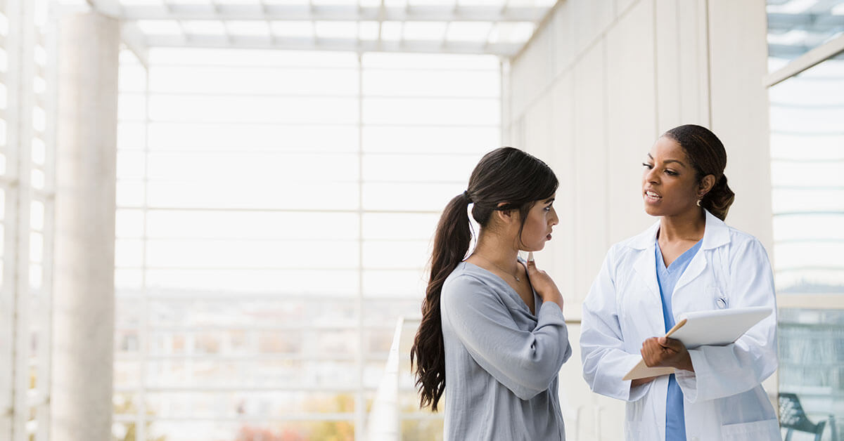 patient and doctor discussing in the hallway