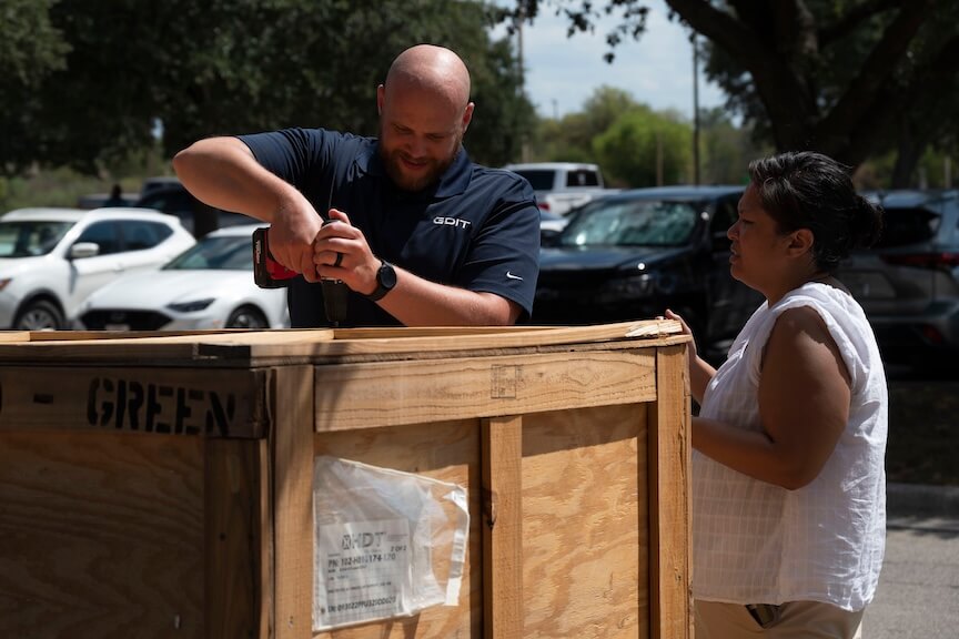 GDIT Employees hacking a crate