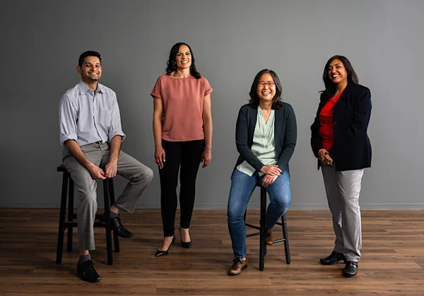 GDIT employees by a wall