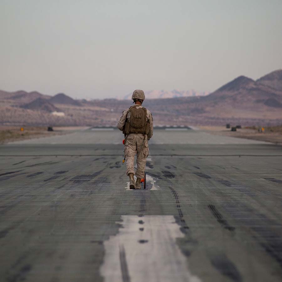 soldier walking on road