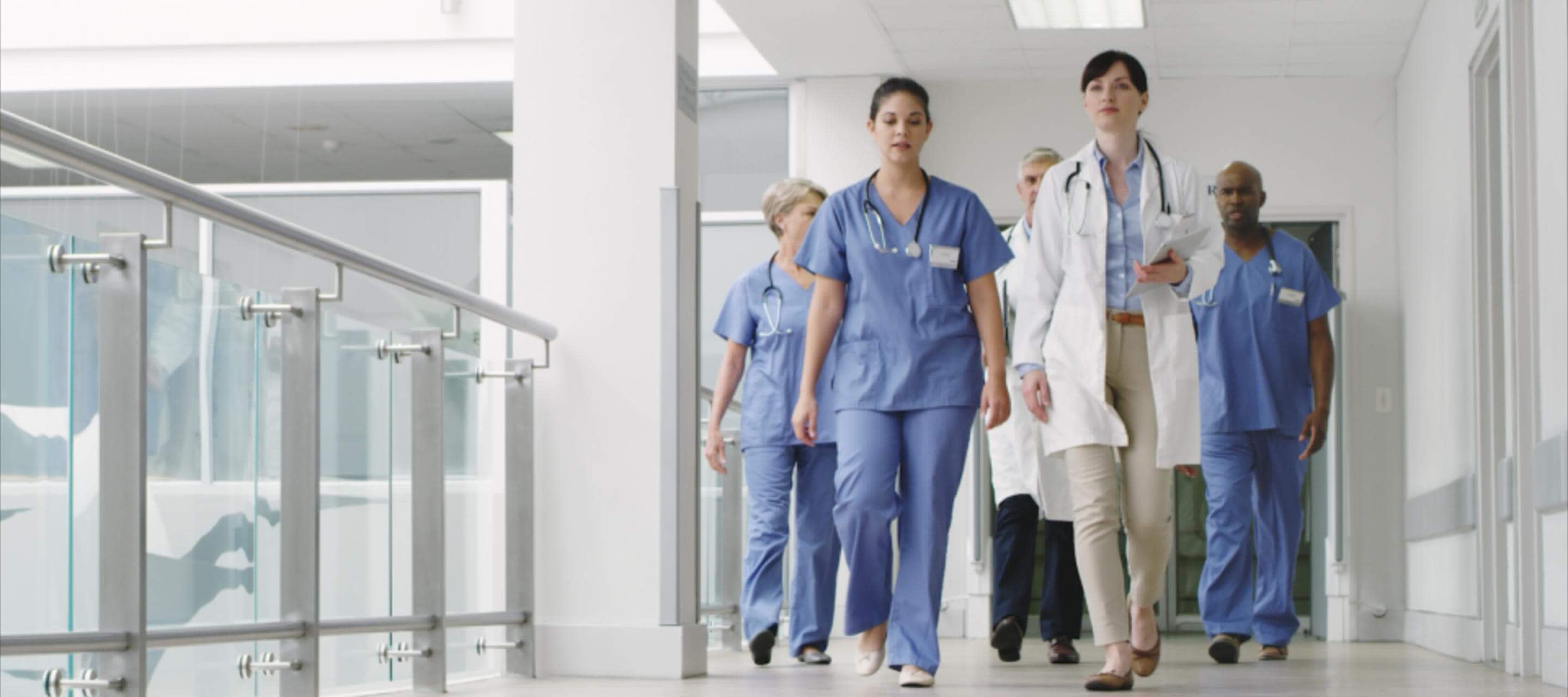 nurses and doctors walking through hospital halls