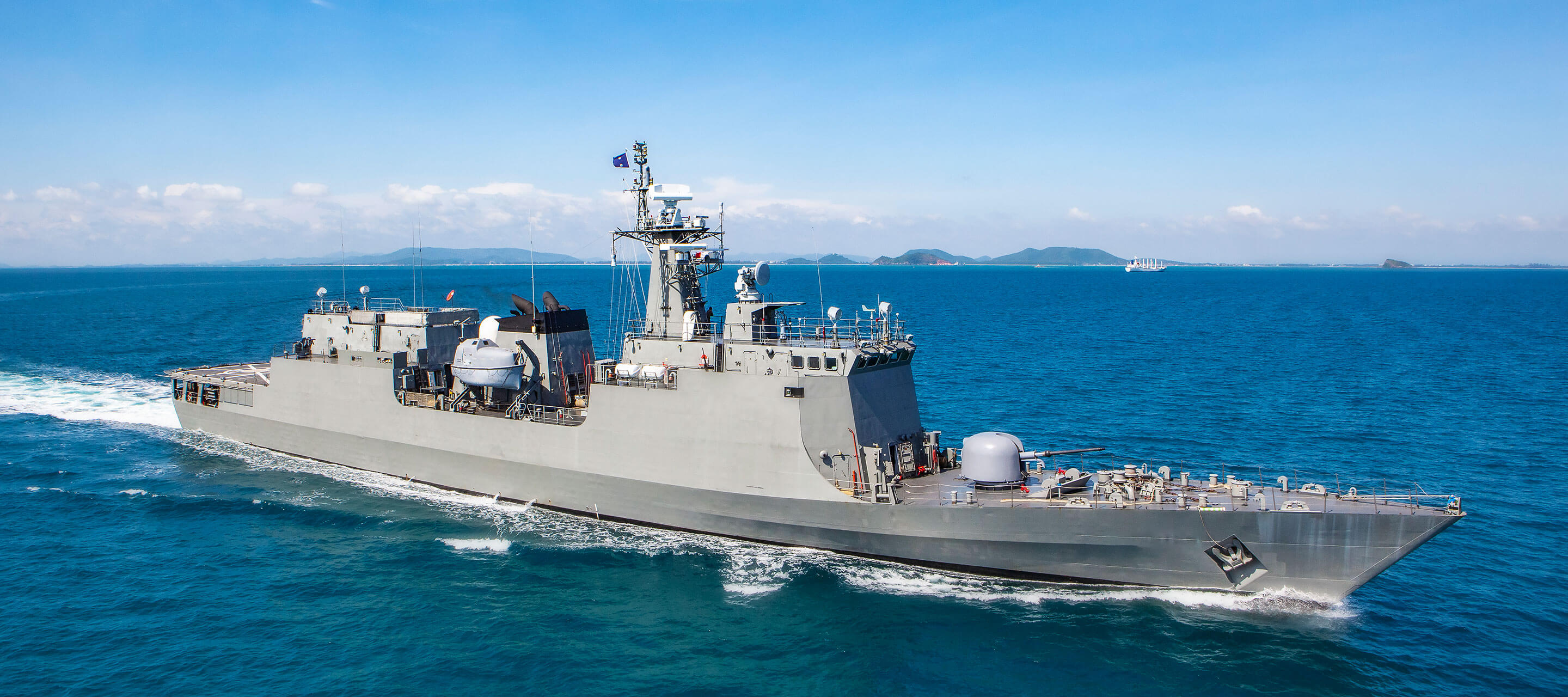 Military navy ship in a sea bay view from helicopter