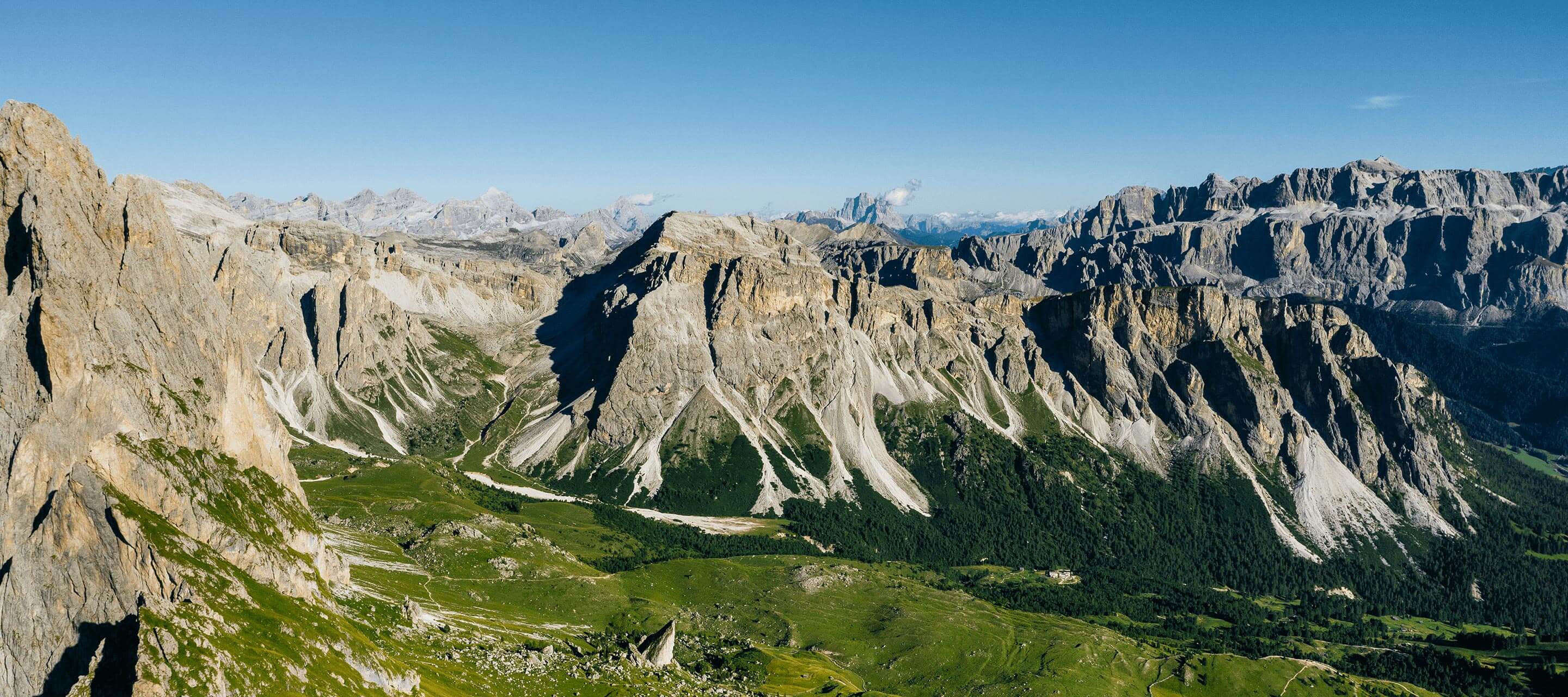 mountains with grass fields on bottom