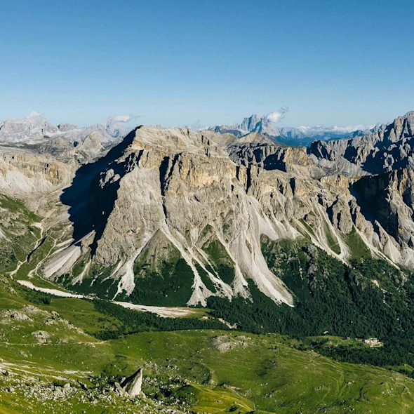 mountains with grass fields on bottom