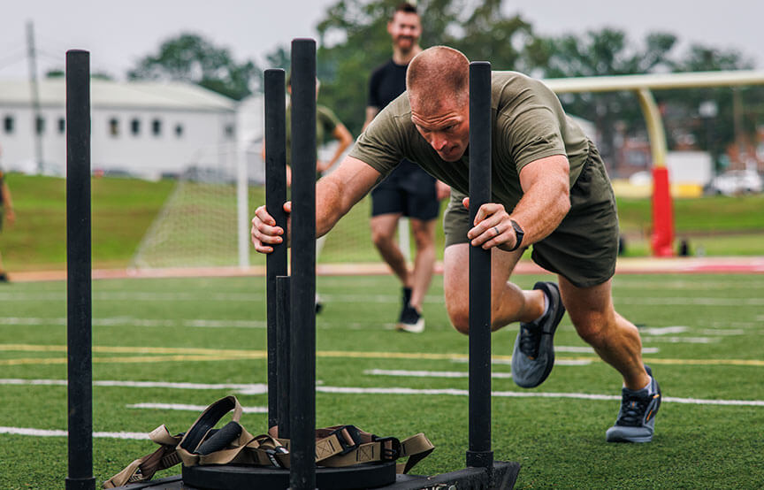 man pushing weights