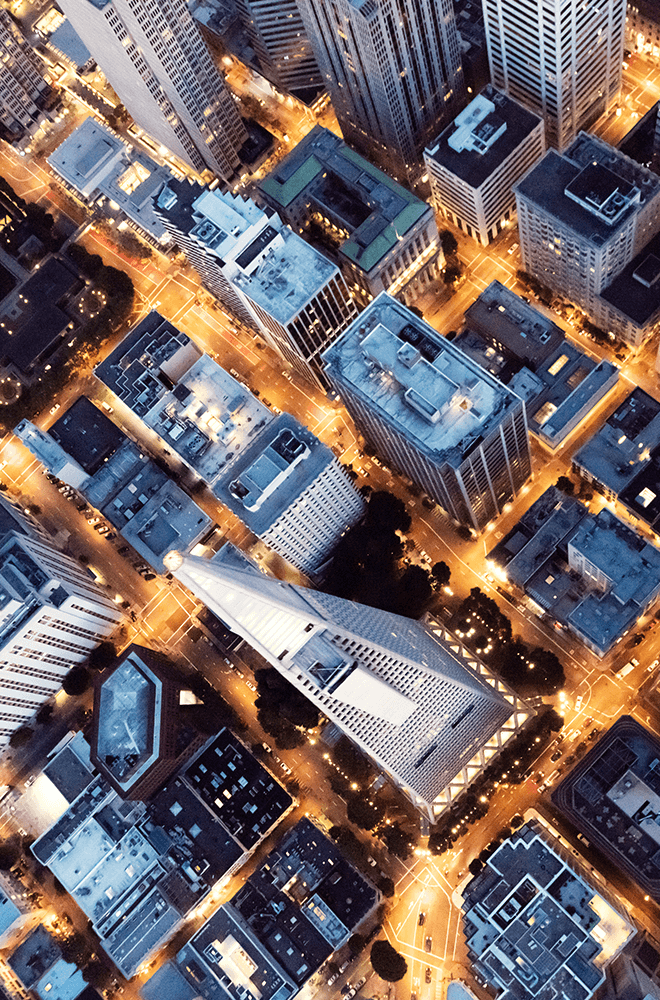 aerial view of city scape with lit up streets