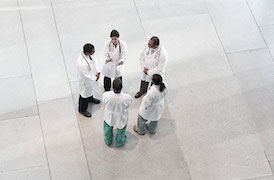 Group of people in scrubs talking