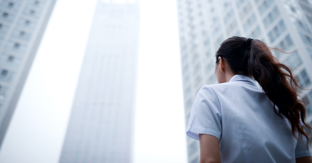 person walking towards building