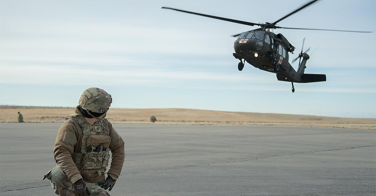image shoes solider on ground looking at medical helicopter