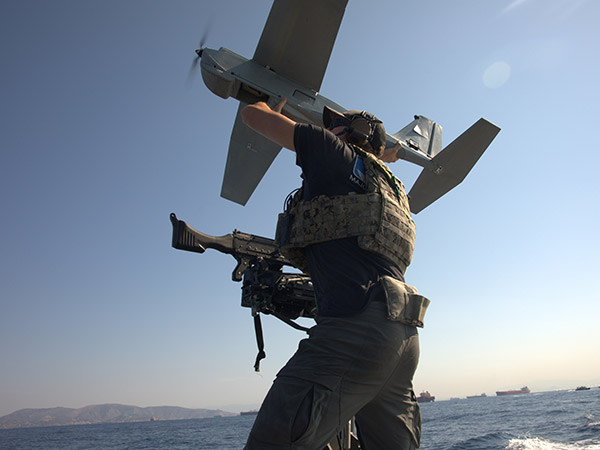 soldier on ground directing air craft above