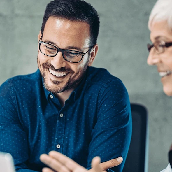male and female smiling at screen
